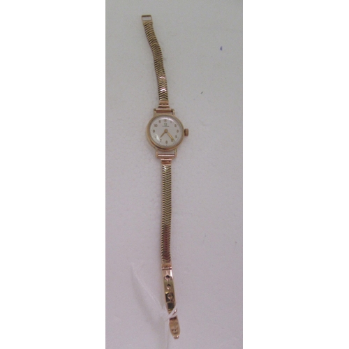 65 - A ladies Omega 9ct gold cased bracelet wristwatch, faced by a gilded Arabic dial, on a flexible stra... 