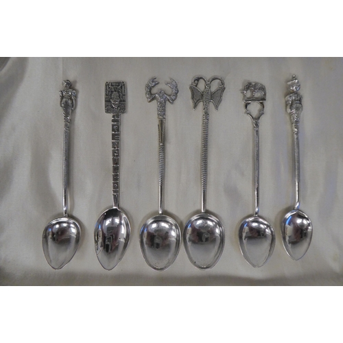 74 - Twelve Indian silver coloured metal spoons, each terminal with an ornamental finial 