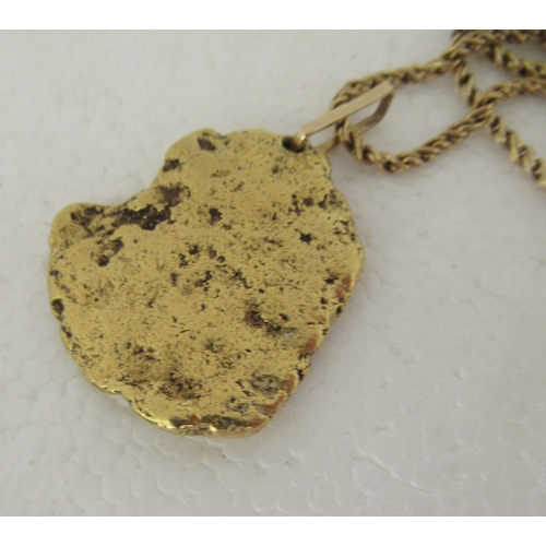 75 - An 18ct gold ropetwist chain with a gold nugget pendant  