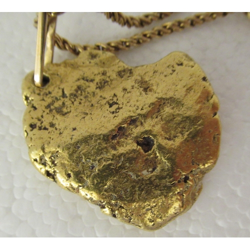 75 - An 18ct gold ropetwist chain with a gold nugget pendant  