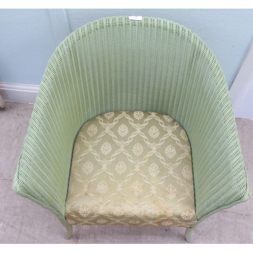 77 - A green painted Lloyd Loom Lusty tub chair, raised on splayed legs