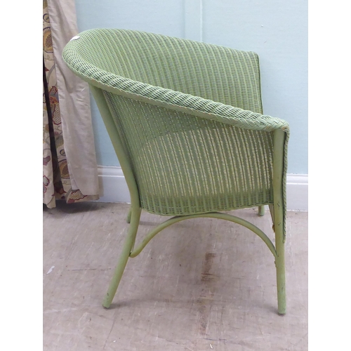 77 - A green painted Lloyd Loom Lusty tub chair, raised on splayed legs