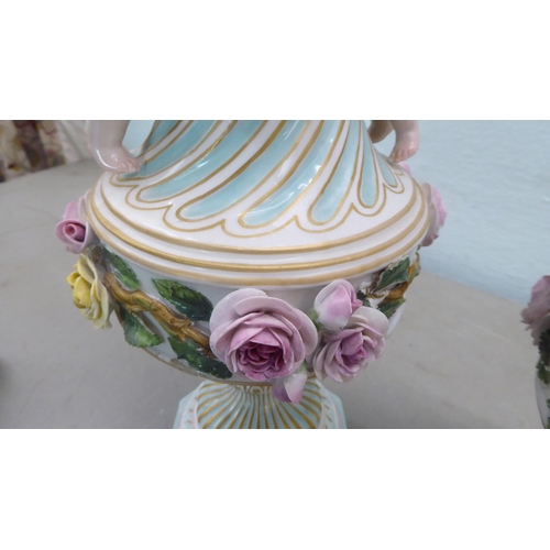 83 - A pair of late 19thC Continental encrusted porcelain pedestal vases and covers, decorated in bright ... 