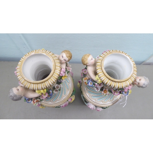 83 - A pair of late 19thC Continental encrusted porcelain pedestal vases and covers, decorated in bright ... 