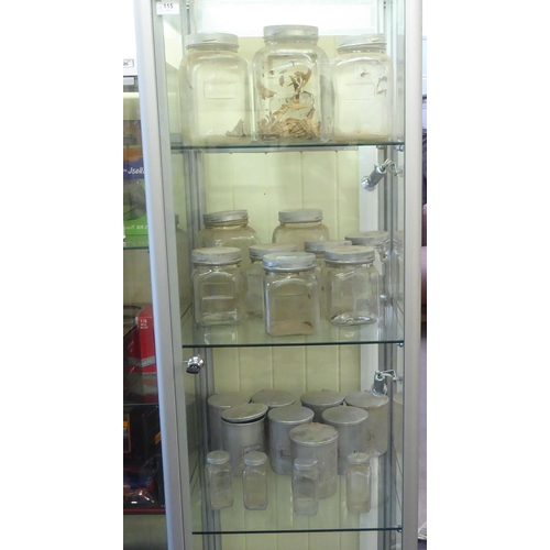 115 - A modern, fully glazed and shelved retailer's display cabinet with a single door, on casters  75