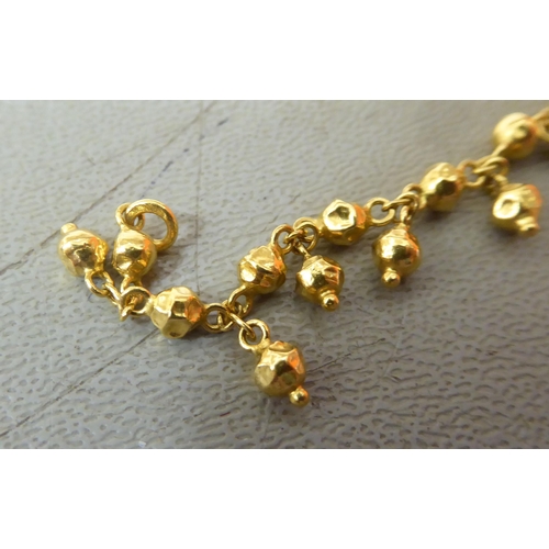 12 - A Chinese high grade gold bead and hoop link bracelet