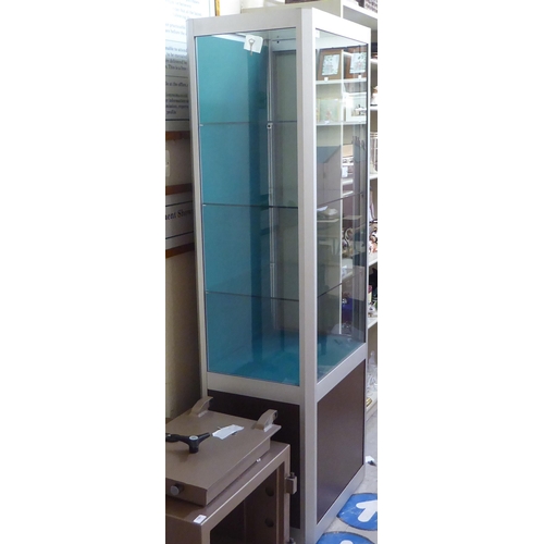 125 - A modern, partially glazed, retailer's display cabinet with a panelled plinth  72