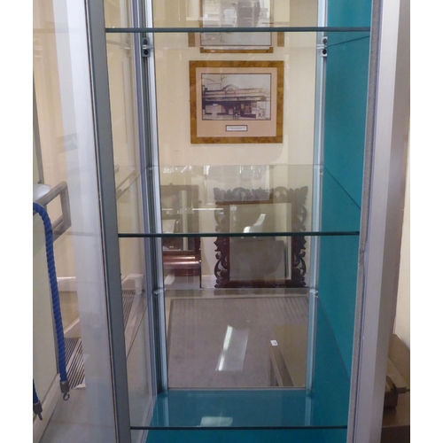 125 - A modern, partially glazed, retailer's display cabinet with a panelled plinth  72