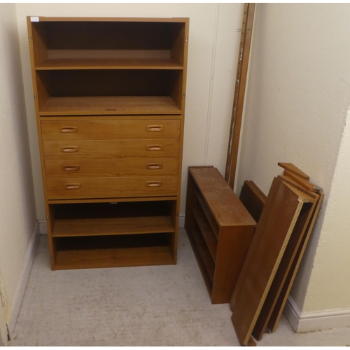 10 - A vintage PS System teak wall unit, comprising an arrangement of open and enclosed shelves, a lockab... 