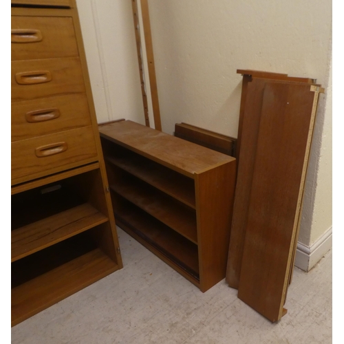 10 - A vintage PS System teak wall unit, comprising an arrangement of open and enclosed shelves, a lockab... 