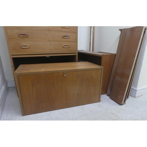 10 - A vintage PS System teak wall unit, comprising an arrangement of open and enclosed shelves, a lockab... 