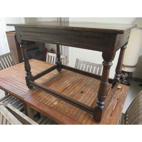 110 - A George III rustic  oak kitchen table, raised on turned, block legs, united by stretchers  28