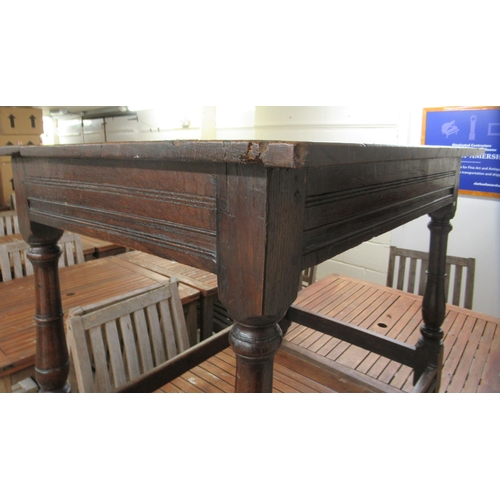 110 - A George III rustic  oak kitchen table, raised on turned, block legs, united by stretchers  28