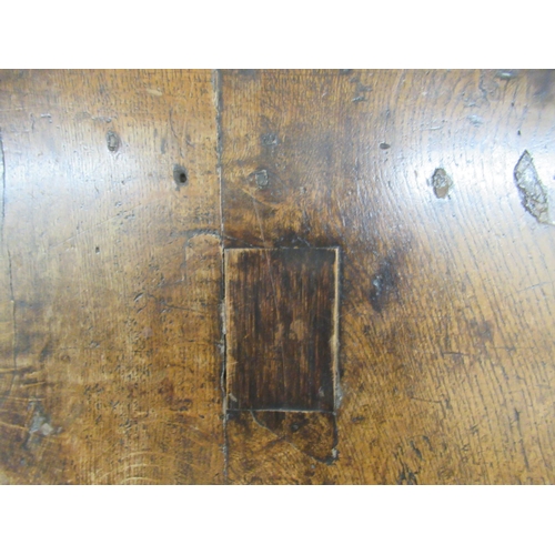 110 - A George III rustic  oak kitchen table, raised on turned, block legs, united by stretchers  28