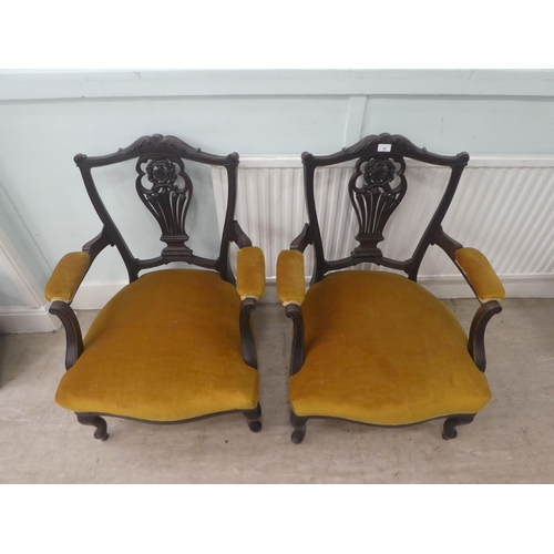 18 - A pair of Edwardian mahogany framed open arm salon chairs, upholstered in old gold fabric, raised on... 