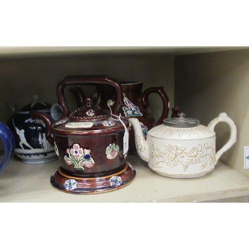 21 - China teapots, decorated in individual designs