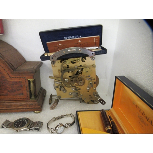 319 - Wristwatches and component parts; a Waterman's pen set; and an Edwardian oak mantel clock case ... 