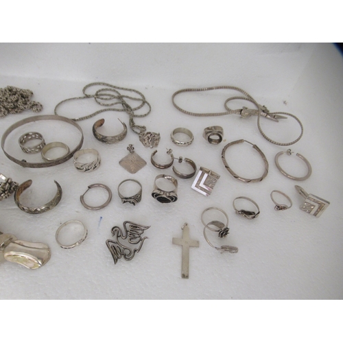 324 - Silver coloured metal jewellery: to include rings, medallions and bangles 