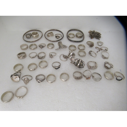 324 - Silver coloured metal jewellery: to include rings, medallions and bangles 