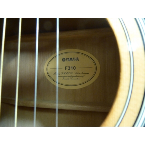 328 - A Yamaha model no. F310 acoustic guitar  cased with a stand 