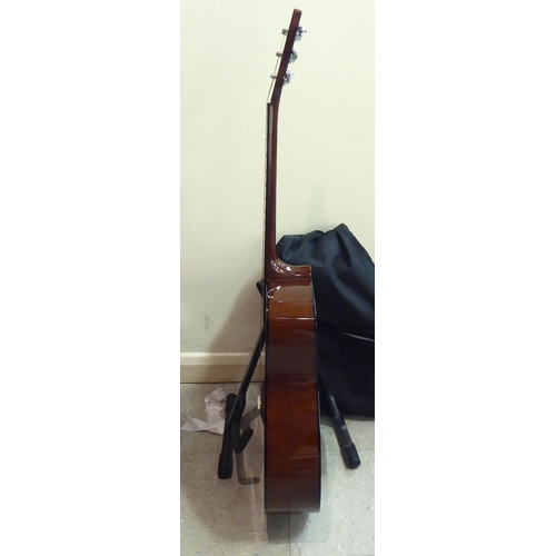 328 - A Yamaha model no. F310 acoustic guitar  cased with a stand 