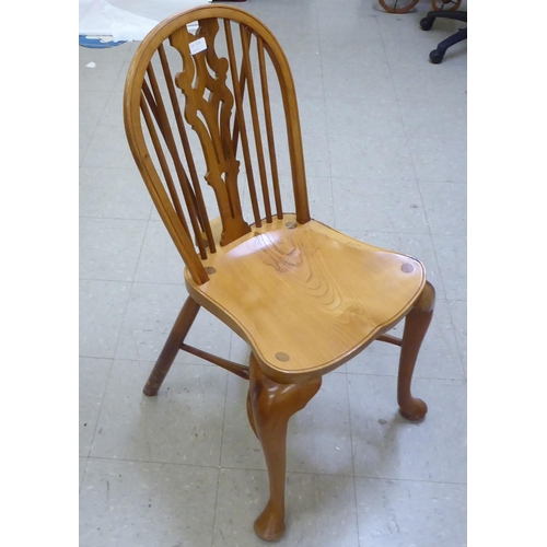 329 - A Stewart Linford yewwood framed Windsor hoop and spindled back chair with a pierced splat and saddl... 