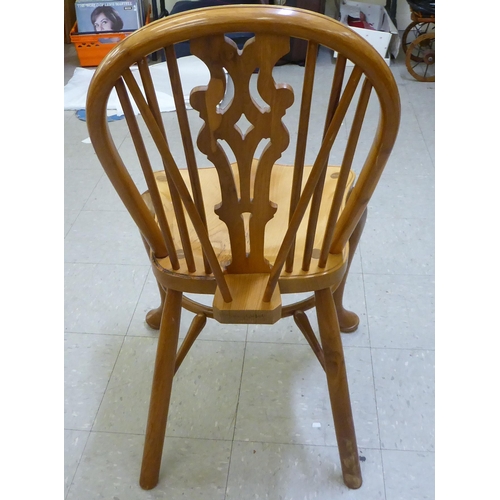 329 - A Stewart Linford yewwood framed Windsor hoop and spindled back chair with a pierced splat and saddl... 