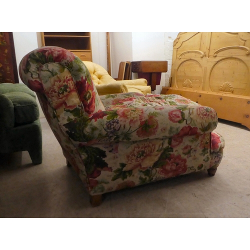 47 - An early 20thC floral patterned fabric upholstered, low, enclosed armchair, raised on block feet&nbs... 