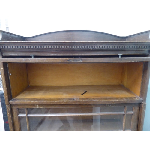 332 - An early 20thC oak three section Globe Wernicke style bookcase, on a plinth  52h  35