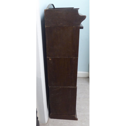 332 - An early 20thC oak three section Globe Wernicke style bookcase, on a plinth  52h  35