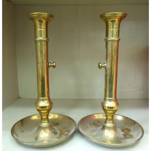 15 - 19thC and later domestic brassware: to include an ornately cast ewer and a pair of ejector candlesti... 