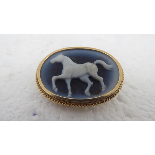109 - A 9ct gold framed cameo, depicting a galloping horse&nbsp;