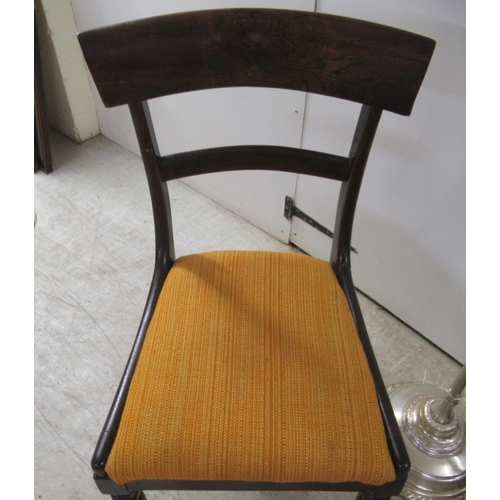 113 - A pair of Victorian mahogany framed round bar crest dining chairs, the upholstered seats raised on t... 