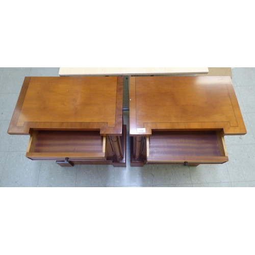 118 - A pair of modern yewwood bedside cupboards, each with a single drawer, over an enclosed shelf, raise... 