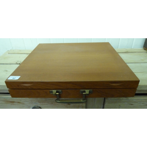 42 - An Indonesian gilt brass canteen with rivetted hardwood handles, in a fitted case&nbsp;