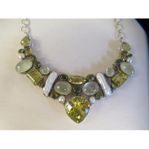 60 - A silver coloured metal multi-gem set necklace, on a dog-clip clasp