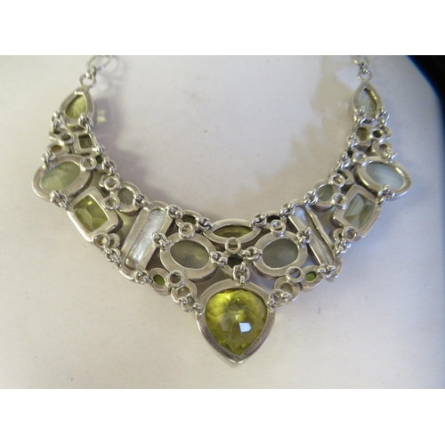 60 - A silver coloured metal multi-gem set necklace, on a dog-clip clasp