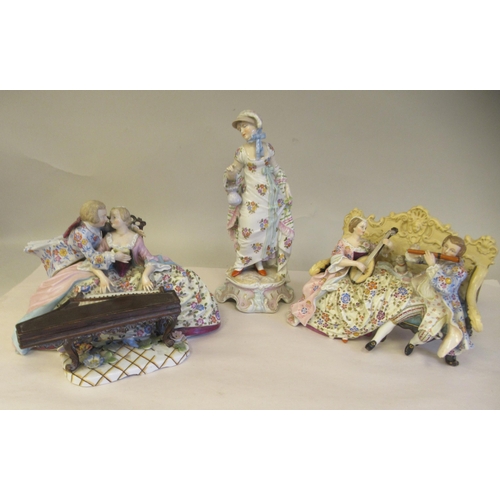 65 - Late 19th/early 20thC Bavarian porcelain figures, viz. a girl wearing a floral dress and bonnet, hol... 