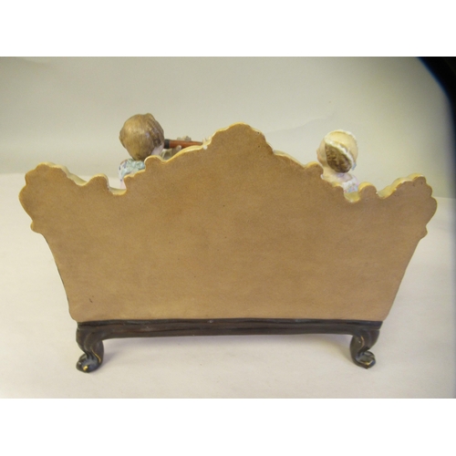 65 - Late 19th/early 20thC Bavarian porcelain figures, viz. a girl wearing a floral dress and bonnet, hol... 