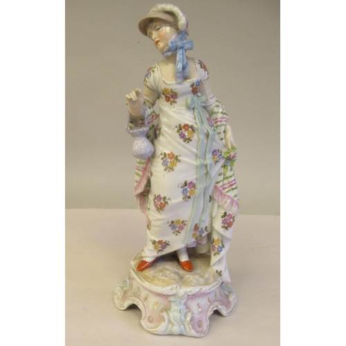 65 - Late 19th/early 20thC Bavarian porcelain figures, viz. a girl wearing a floral dress and bonnet, hol... 