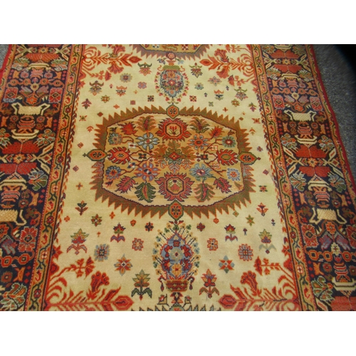67 - A Persian Bachtia design rug, on a burnt orange and multi-coloured ground&nbsp; 54