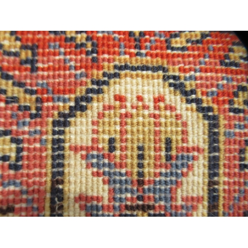 67 - A Persian Bachtia design rug, on a burnt orange and multi-coloured ground&nbsp; 54