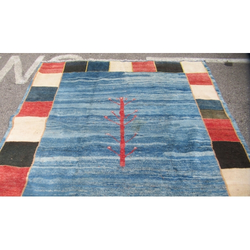 70 - A Gabbeh Shiraz woollen carpet, decorated in bright colours, on a pale ground, bordered by box desig... 