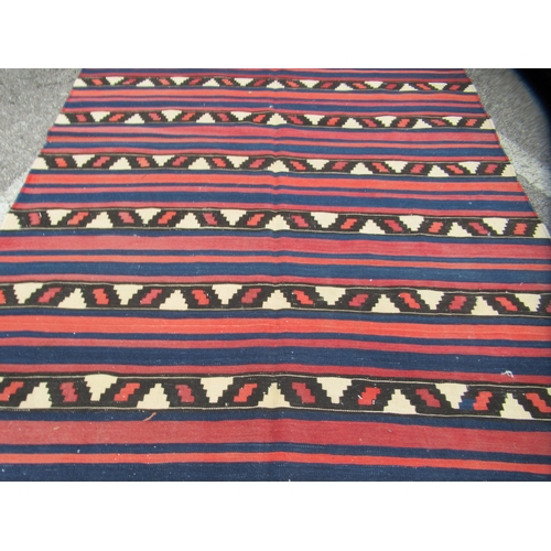 71 - A Kelim rug, decorated with repeating bands of colours and stylised design, on a multi-coloured grou... 