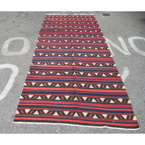 71 - A Kelim rug, decorated with repeating bands of colours and stylised design, on a multi-coloured grou... 