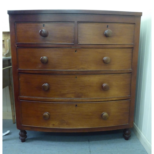 74 - A late Victorian mahogany bow front dressing chest with two short/three long drawers and bun handles... 