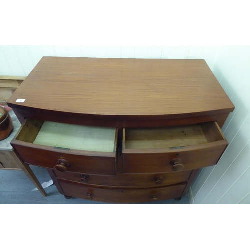 74 - A late Victorian mahogany bow front dressing chest with two short/three long drawers and bun handles... 