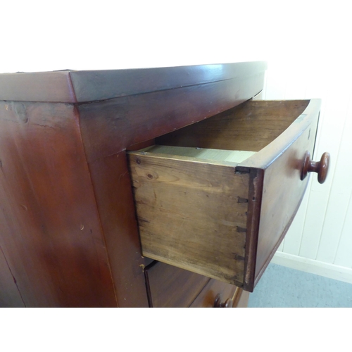 74 - A late Victorian mahogany bow front dressing chest with two short/three long drawers and bun handles... 