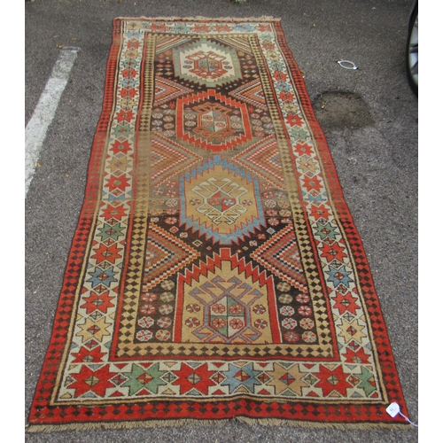 75 - A North African design rug, decorated with repeating star and other designs, on a multi-coloured gro... 