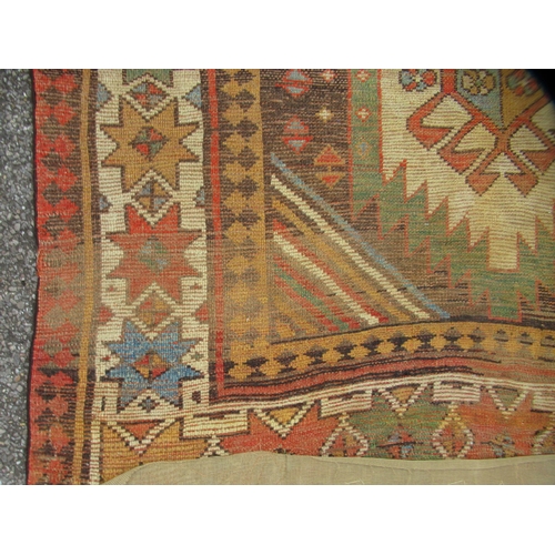 75 - A North African design rug, decorated with repeating star and other designs, on a multi-coloured gro... 